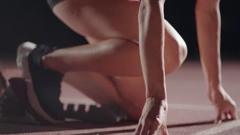 slow-motion-female-runner-at-the-start-close-up-in-the-dark-at-the-stadium-professional-runner-athletic